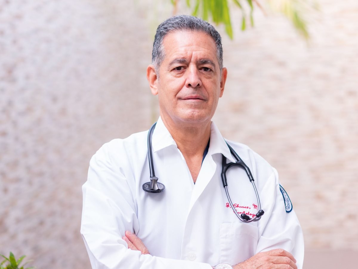 Doctor in a white coat standing with arms folded