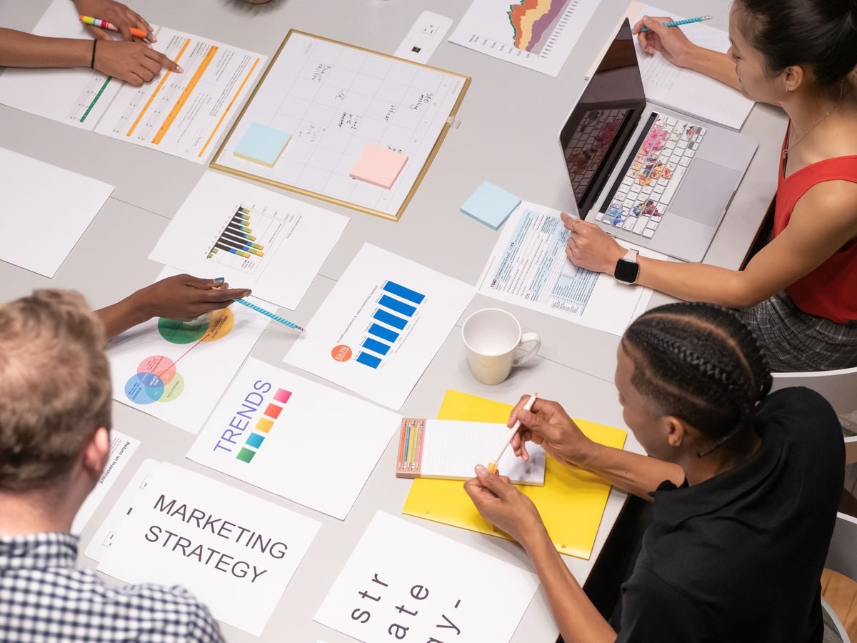 A marketing team planning a strategy around a table