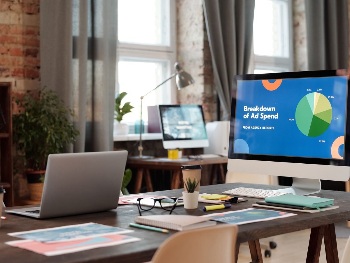 Agency desk with a monitor showing a campaign report