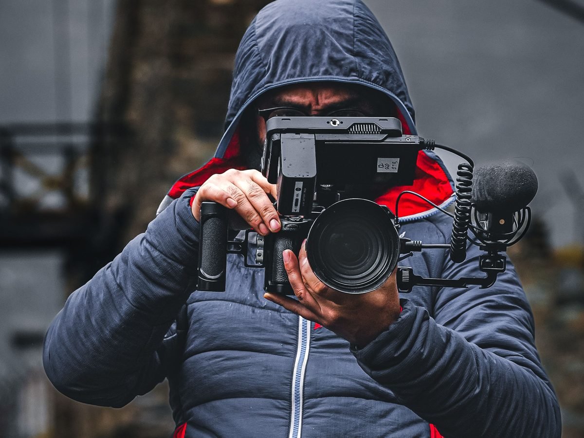 Camera operator filming with a rigged video camera